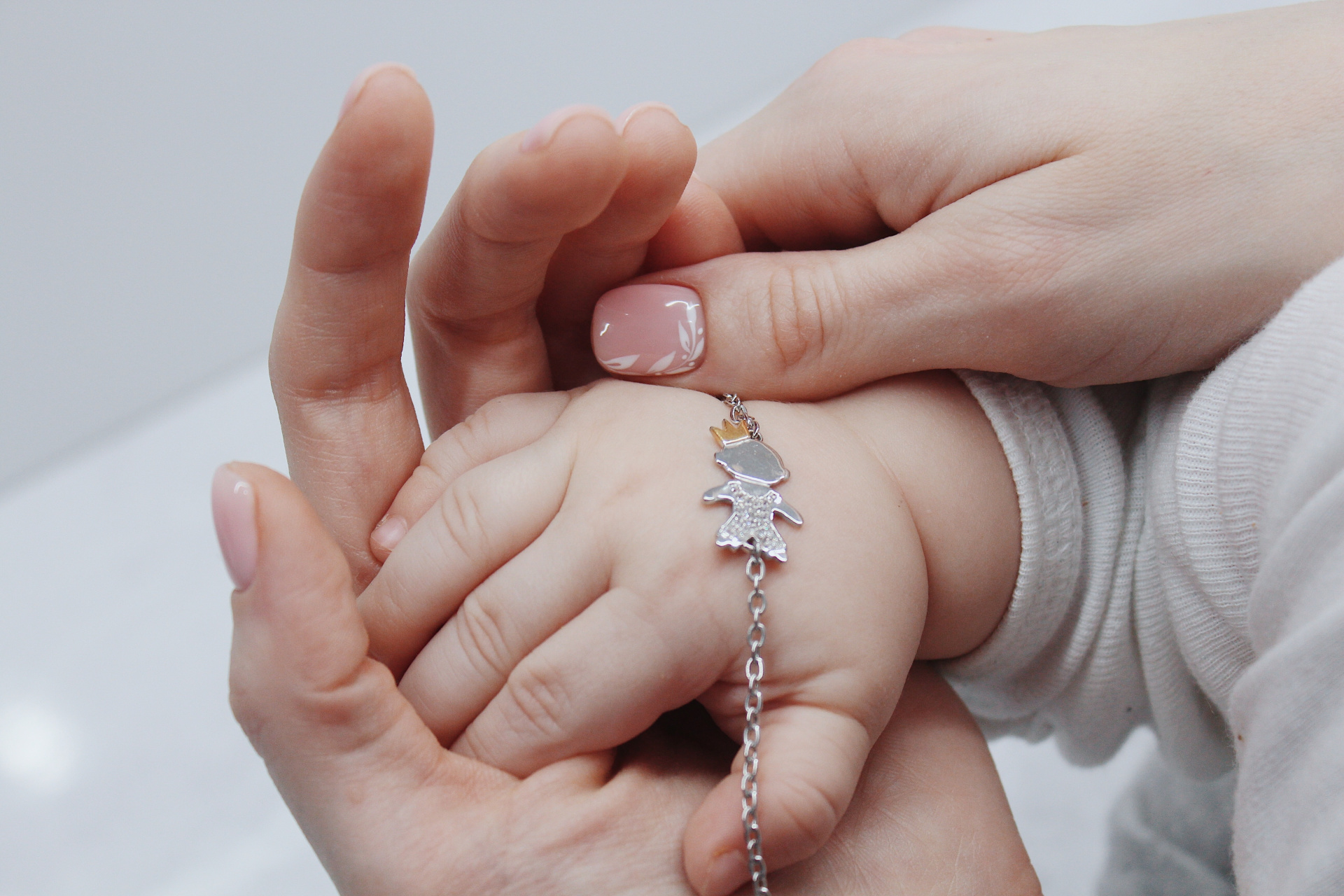 closeup-shot-female-putting-cute-bracelet-her-baby-s-hand.jpg